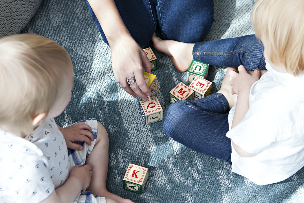 children with hearing loss play with wooden blocks