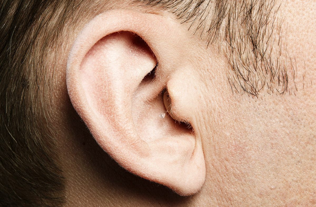 completely in canal hearing aid inserted in mans right ear in lancaster hearing aid center