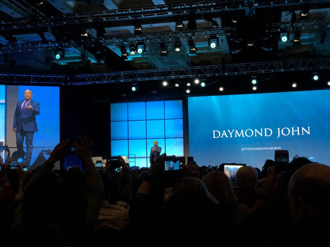 daymond john on stage at starkey hearing aid convention
