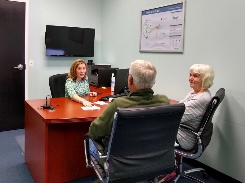 hearing aid provider talks to patients in elizabethtown office