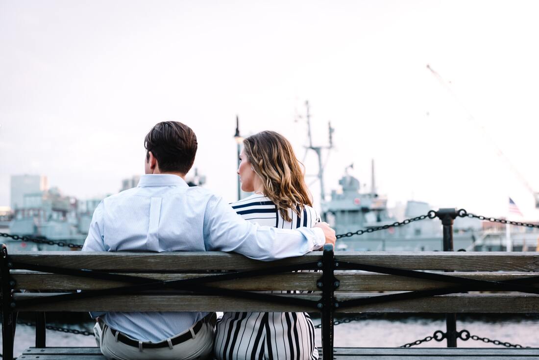 man and woman with hearing loss sit on a bench during a date