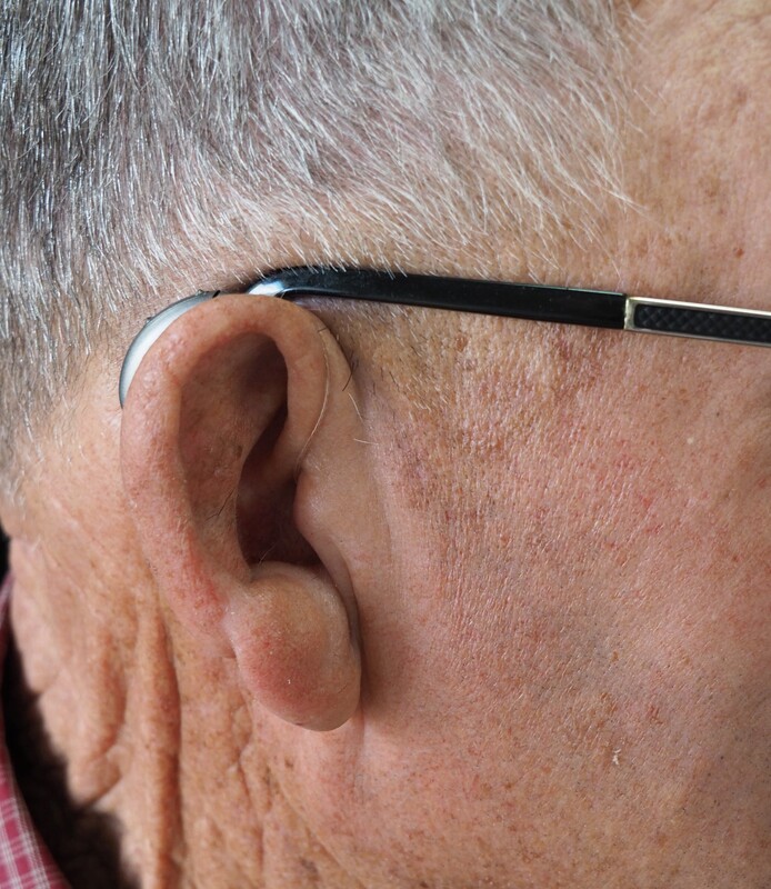 man receives new hearing aid fitting with a free trial