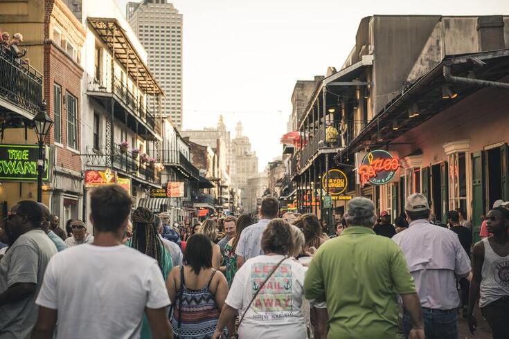 crowds with hearing aid users walking through people in new orleans