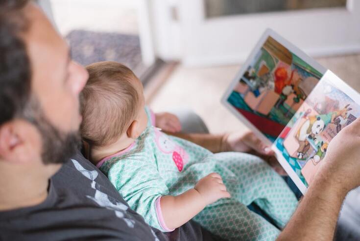 dad shows book to baby with hearing loss