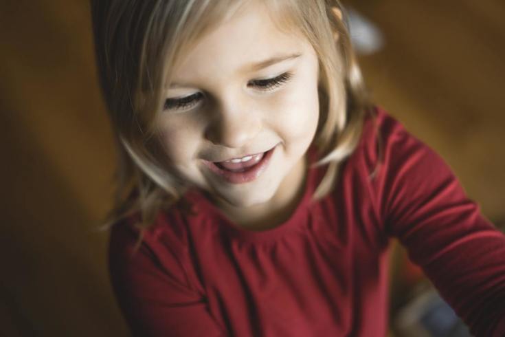 little_girl_with_hearing_loss_smiling_and_learning_at_home