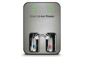 A smart li-ion power charger features a pair of hearing aids charging.