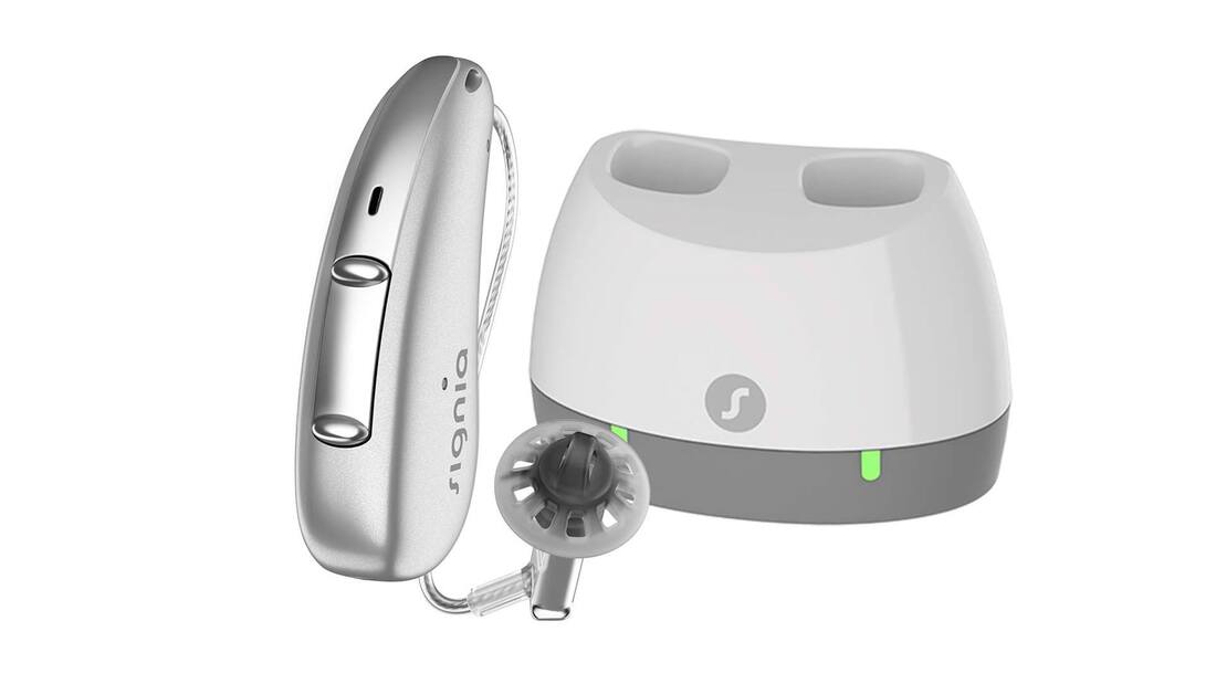 signia silver bte cros hearing aid with white and grey desktop charger available near strasburg rail road