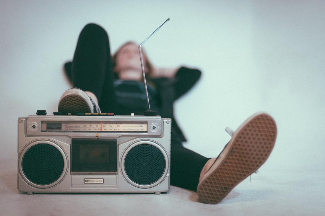 teenager_lying_down_and_listening_to_loud_radio