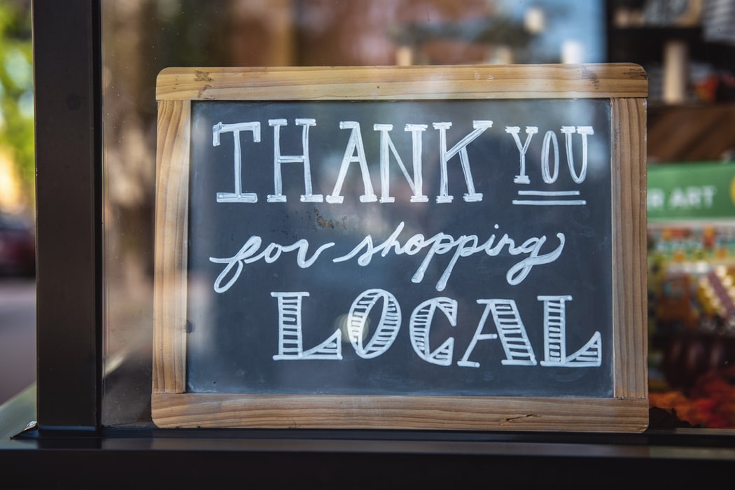thank you for shopping local black chalkboard sign with wooden frame written in white chalk