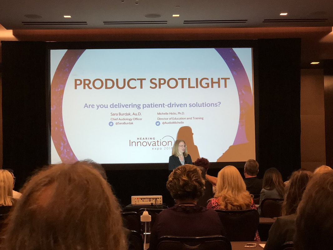 woman in spotlight on stage highlights hearing aid products