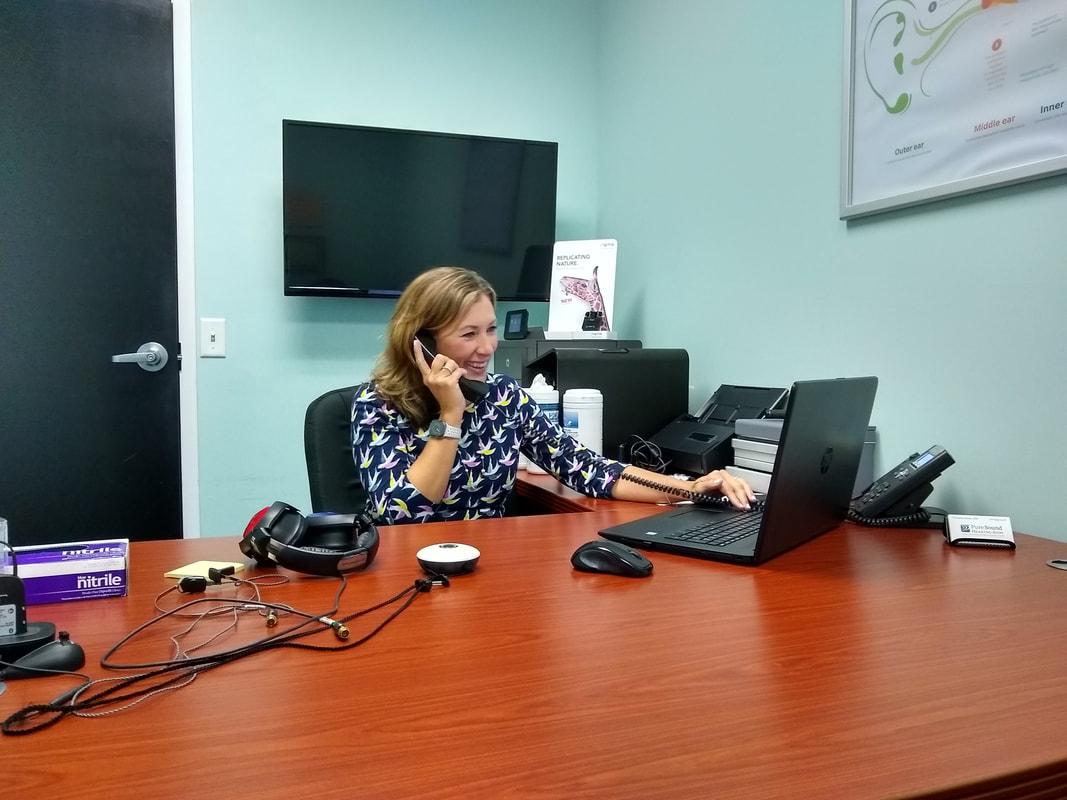 woman talks on phone at desk in elizabethtown office